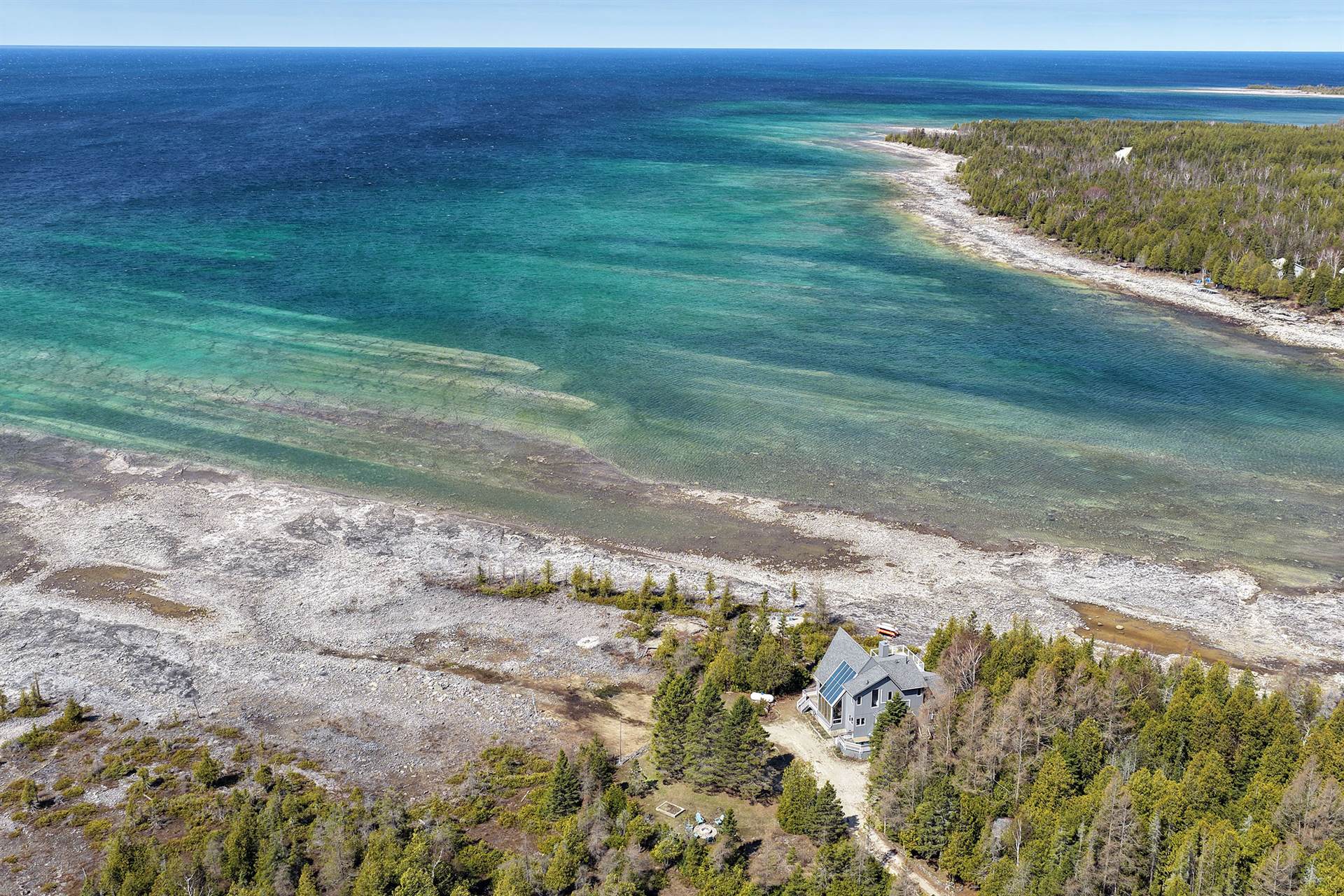 Aerial view of Casolena and its private limestone shoreline on turquoise Lake Huron